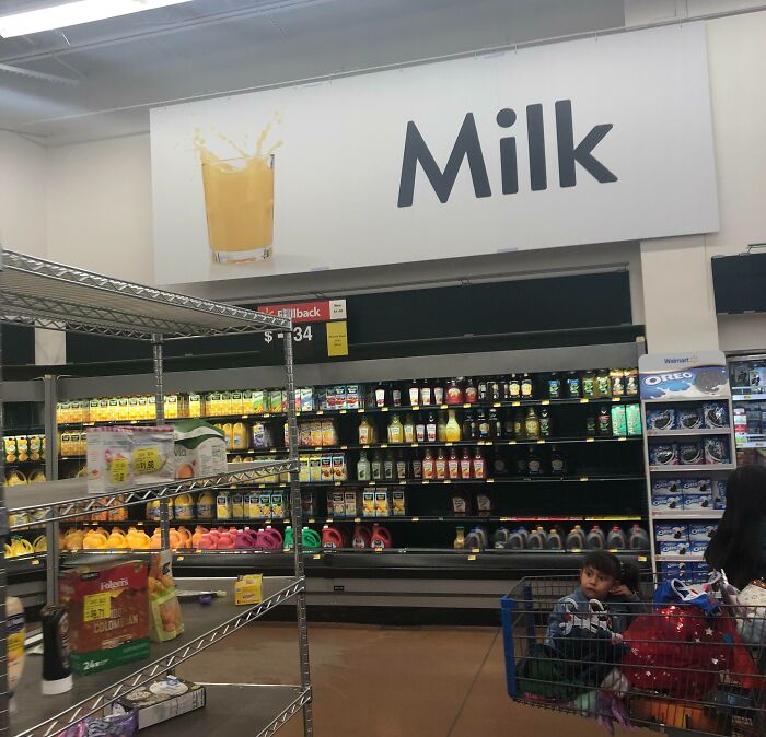Supermarket aisle labeled as milk with shelves stocked with juice and condiments, an example of advertising placement fails.