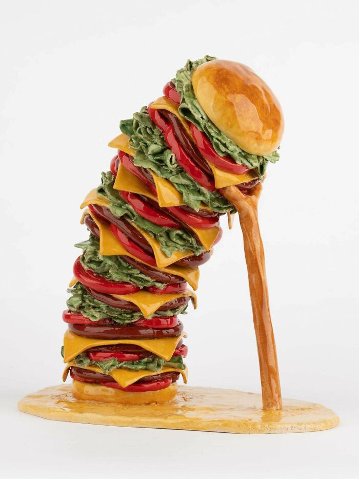 Creative sculpture of a towering cheeseburger with multiple layers, showcasing something people made so cool to share.