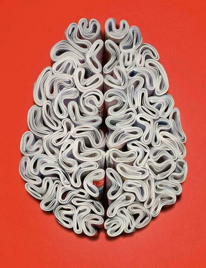 Rolled newspapers arranged to resemble a brain, showcasing creative design making the world smarter and cooler.