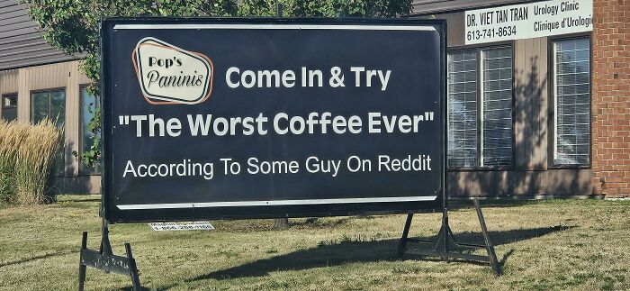 Sign outside Pop's Paninis humorously inviting people to try the worst coffee ever, a random note reminding us not to take life seriously.