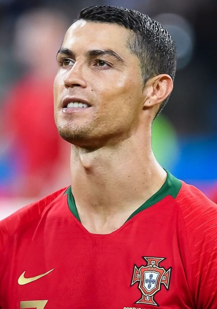 Soccer player in Portugal jersey, close-up portrait showcasing highest paid athletes of 2025 in sports.