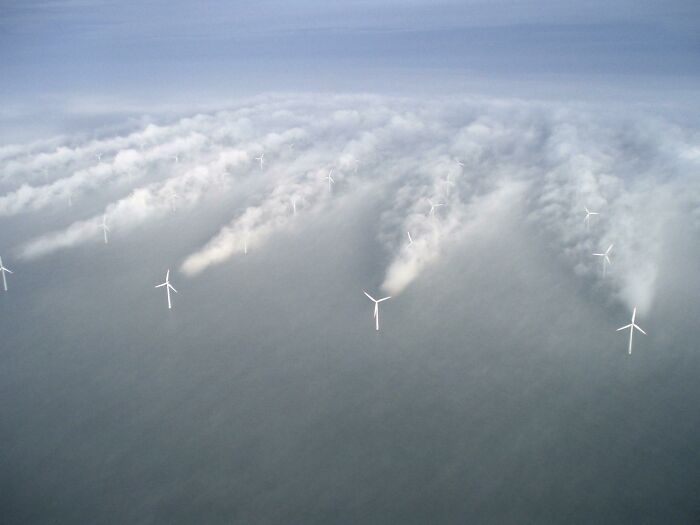 Offshore wind turbines in Denmark generating clean energy, showcasing modern sustainable technology and innovation.