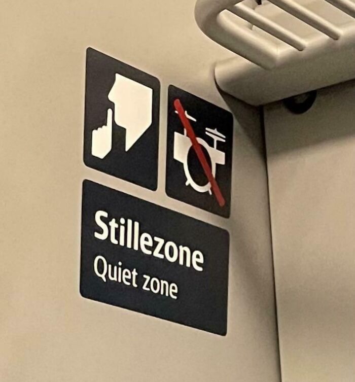 Quiet zone sign inside a Danish prison cell, emphasizing silence and no musical instruments allowed.