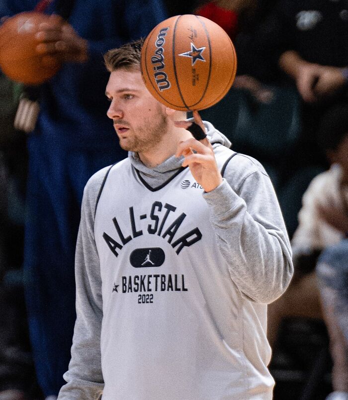 Basketball player spinning a ball on his finger during an All-Star practice, representing highest paid athletes 2025.