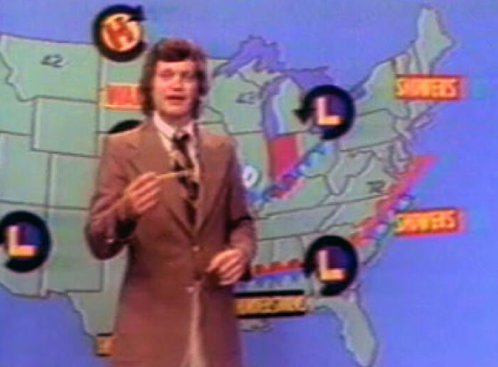 Vintage TV weatherman in a brown suit presenting weather forecast on a classic United States map, nostalgic feel.