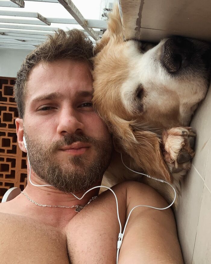 Man lying next to Theo the Golden Retriever, both resting closely together in a peaceful moment. Man lying next to Theo the Golden Retriever, both resting closely together in a peaceful moment.
