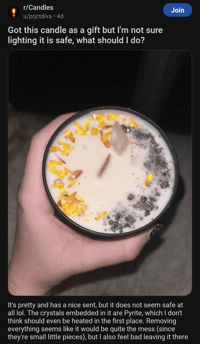 Hand holding a decorative candle with crystals and flower petals, raising concerns about safety and edible risks.