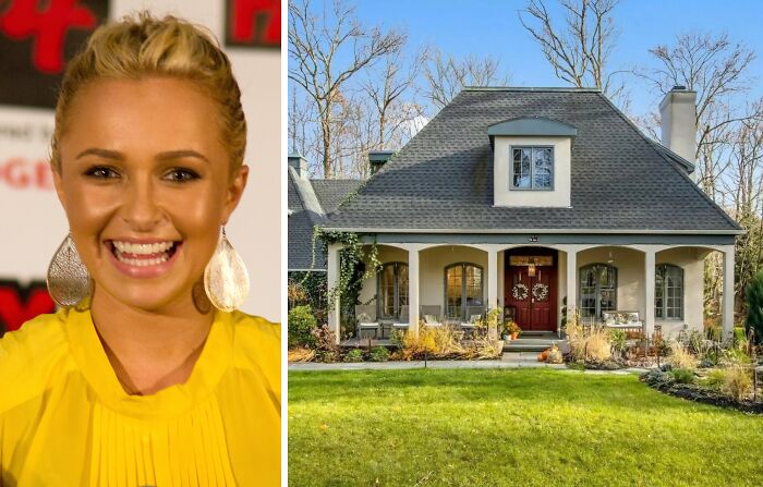 Celebrity smiling woman wearing yellow top beside a large childhood home with a porch and decorated front door.