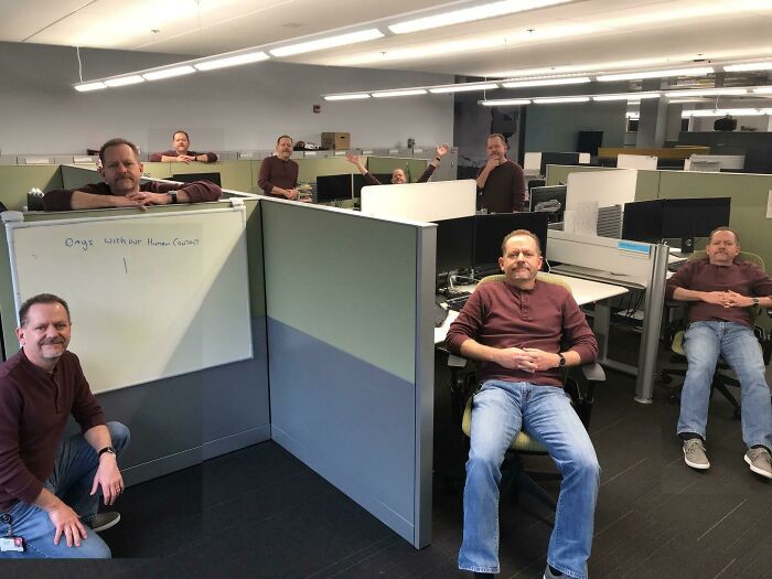 Man in the office cloned multiple times, illustrating a humorous scene related to funniest parents ever.