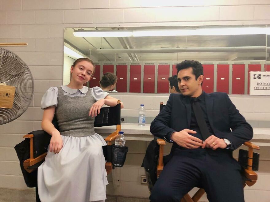 Sydney Sweeney sitting with a man in a dressing room, reflecting business ventures and net worth in 2025. Sydney Sweeney sitting with a man in a dressing room, reflecting business ventures and net worth in 2025.