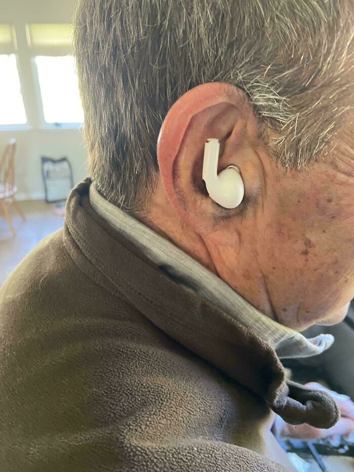 Elderly man wearing a single wireless earbud, showcasing one of the funniest parents ever moments.