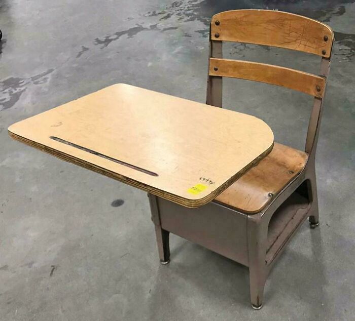 Vintage wooden school desk with metal frame and attached writing surface, evoking nostalgic feel old as heck posts.