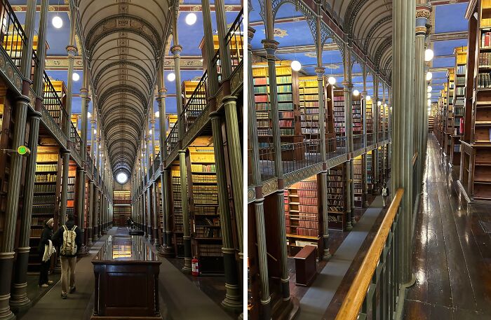 Historic Danish library interior with tall bookshelves, ornate columns, and visitors exploring the vast collection.