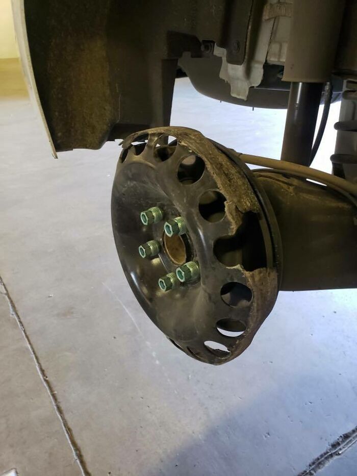 Worn-out car wheel rim with damaged edges showing the challenges car mechanics had to deal with.