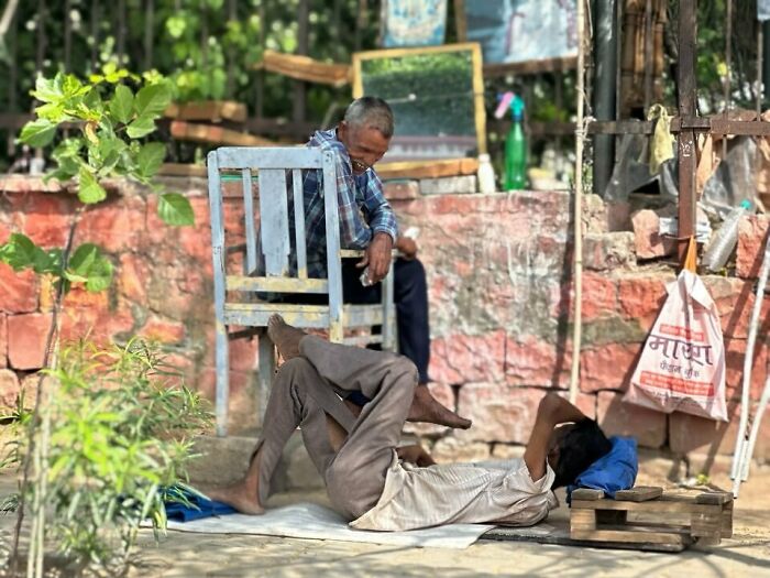 Two men resting outdoors in a street photography scene capturing humanity in its purest form through candid moments.
