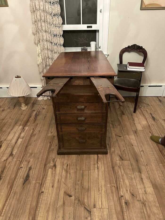 Antique wooden desk with hidden extendable armrests, one of the curious things people discovered and had no idea what they were. Antique wooden desk with hidden extendable armrests, one of the curious things people discovered and had no idea what they were.