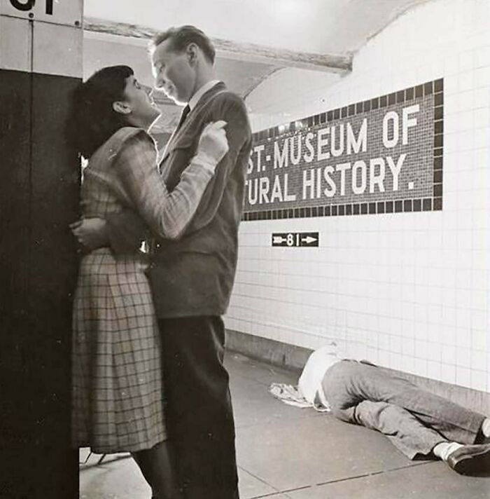 Couple embracing in a subway station, with a person lying on the floor, captured in old photos showing lives from a different time.