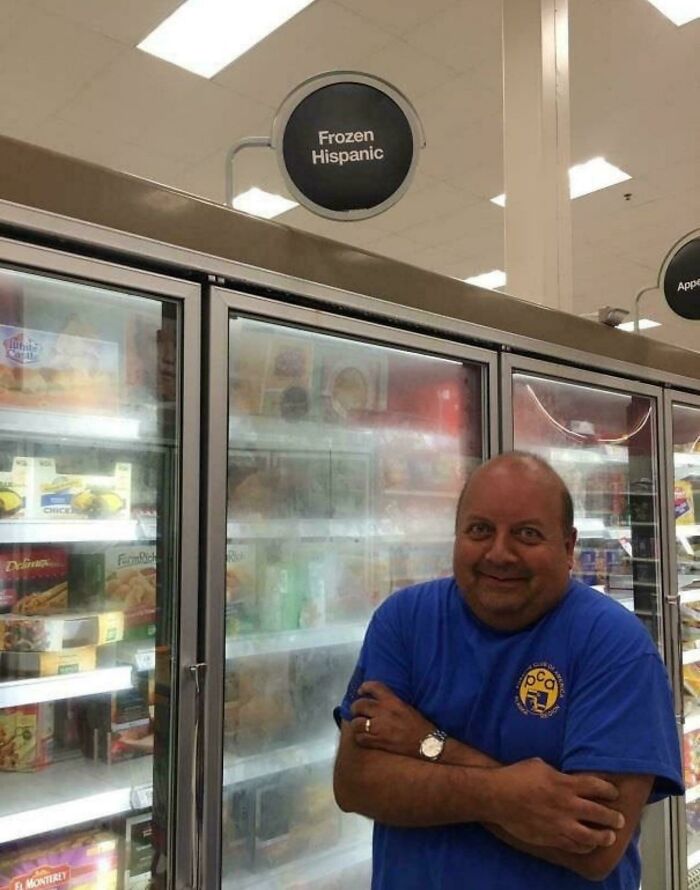 Man smiling and standing frozen in front of freezer labeled frozen Hispanic in a funny and bizarre image combining the holy and the cursed