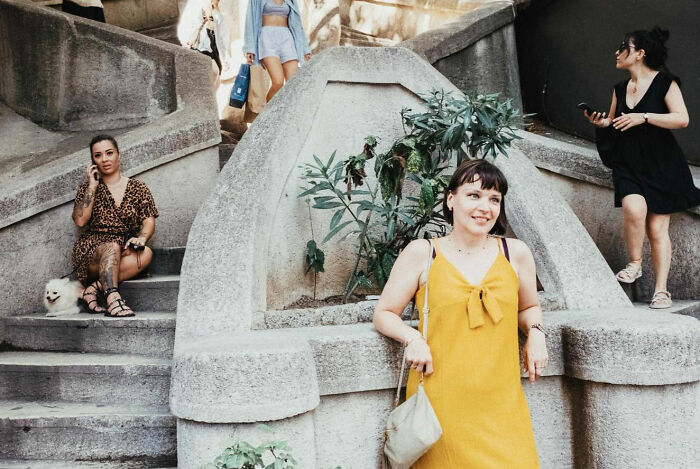 Women in casual dress interacting on urban stone stairs, showcasing the real candid side of life in Turkey.