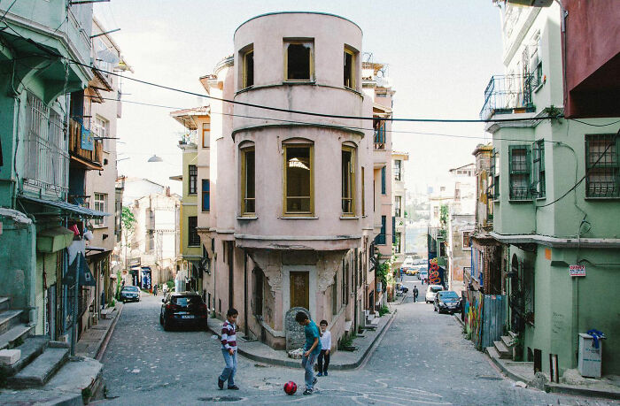 Children playing soccer on a street in Turkey, capturing the real, candid side of life in urban neighborhoods by Yusuf Aksoy.
