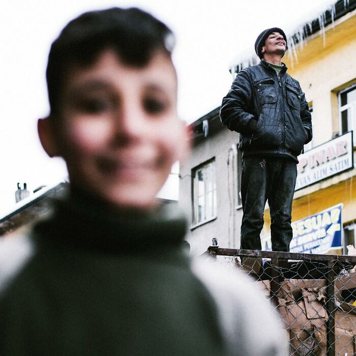 Two men captured candidly outdoors, showcasing real life moments in Turkey through Yusuf Aksoy's photography.