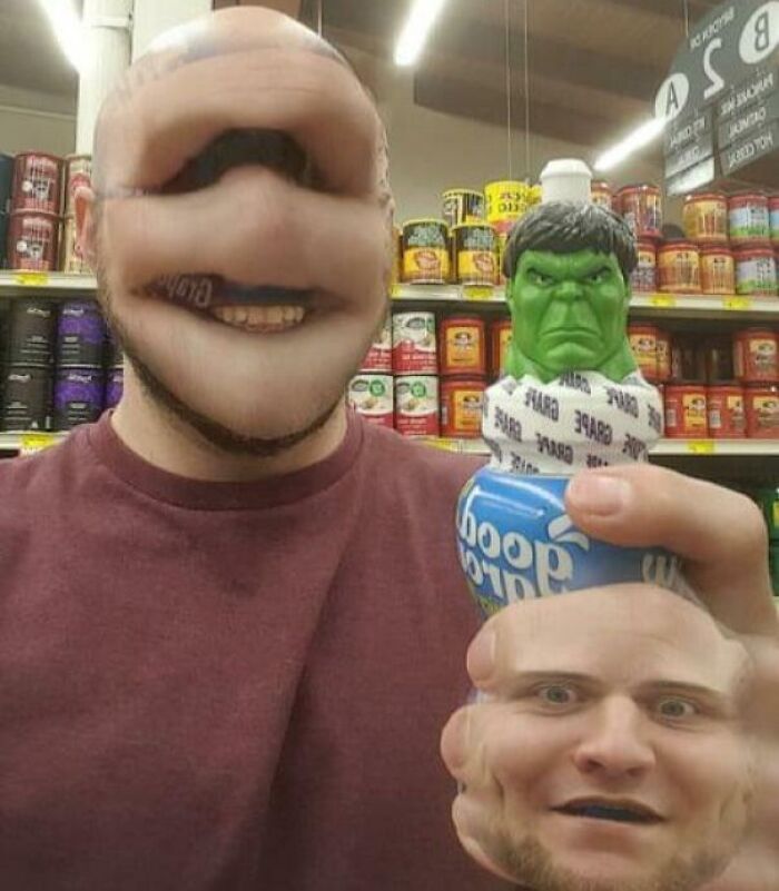 Man with distorted face filters holding a bizarre and funny figurine combining the holy and the cursed in a store aisle.