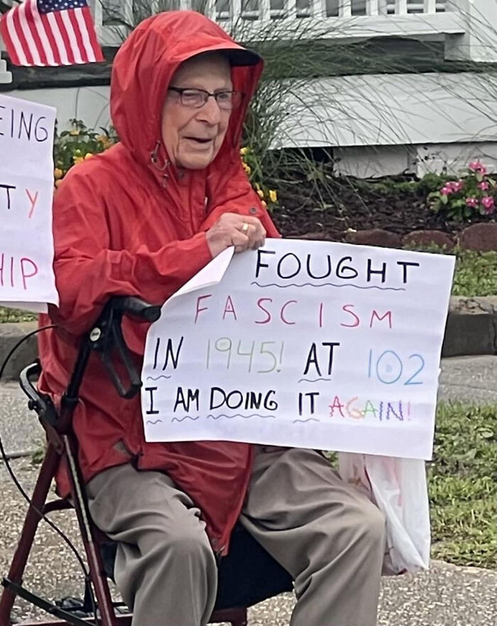 Elderly man showing chaotic good sign about fighting fascism at 102, symbolizing people who did the right thing in their own way.