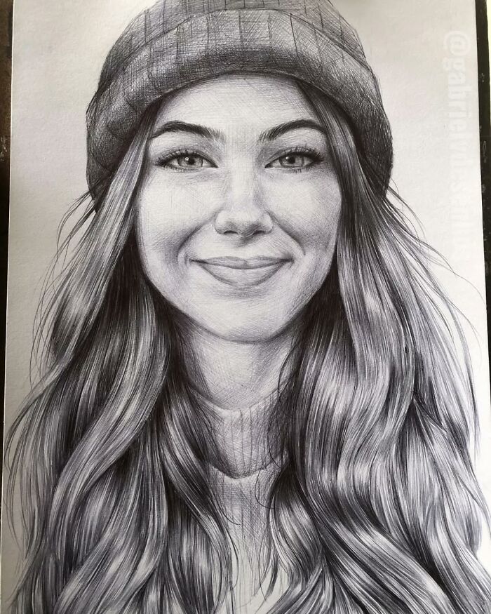 Realistic ballpoint pen portrait of a smiling woman with long hair and a beanie, showcasing detailed pen art skills.