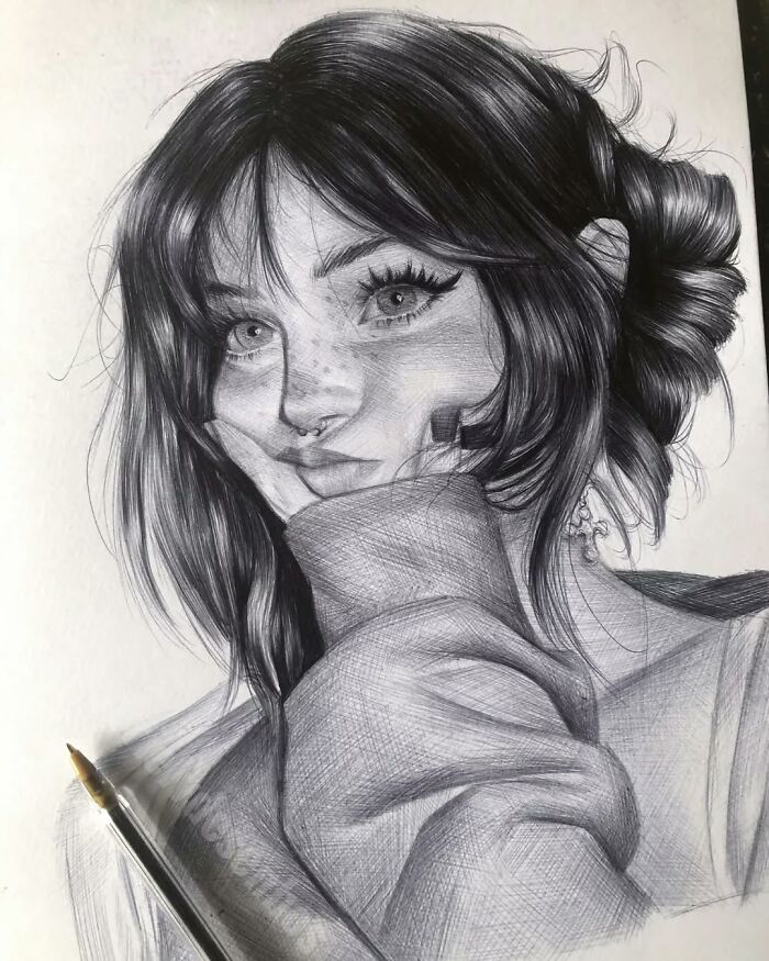 Ballpoint pen portrait of a young woman with detailed hair and facial features, showcasing realistic shading and texture.