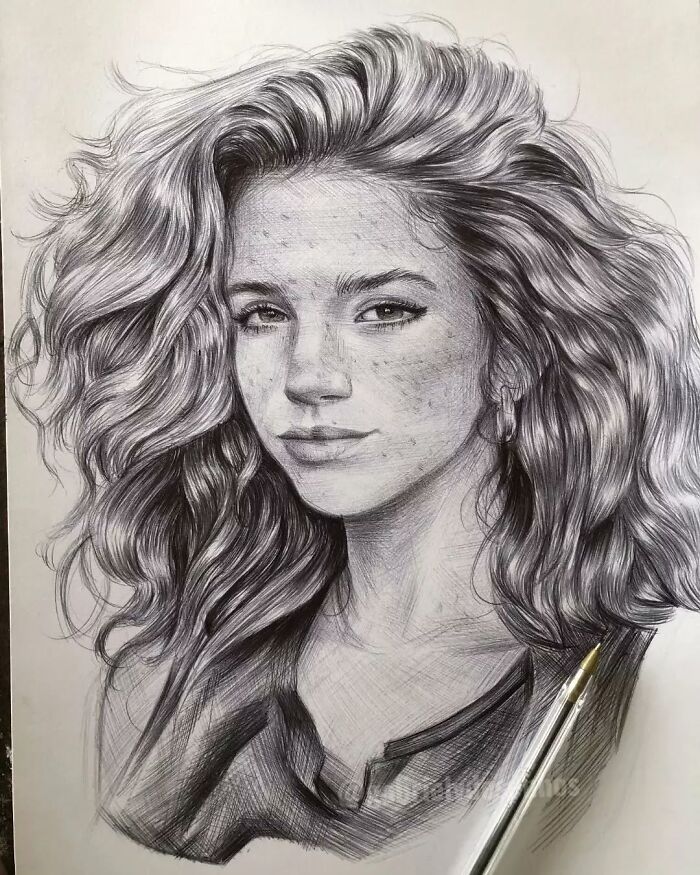 Hyper-realistic portrait drawn with a ballpoint pen showcasing intricate hair and facial details that look photographed.