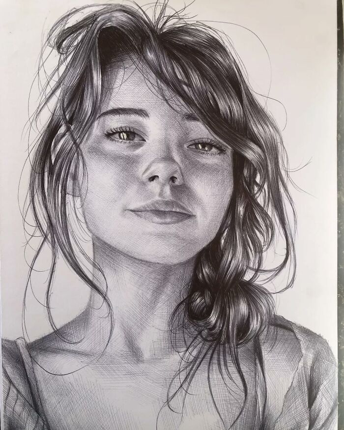 Realistic ballpoint pen portrait of a young woman with loose hair and detailed facial features, resembling a photograph.