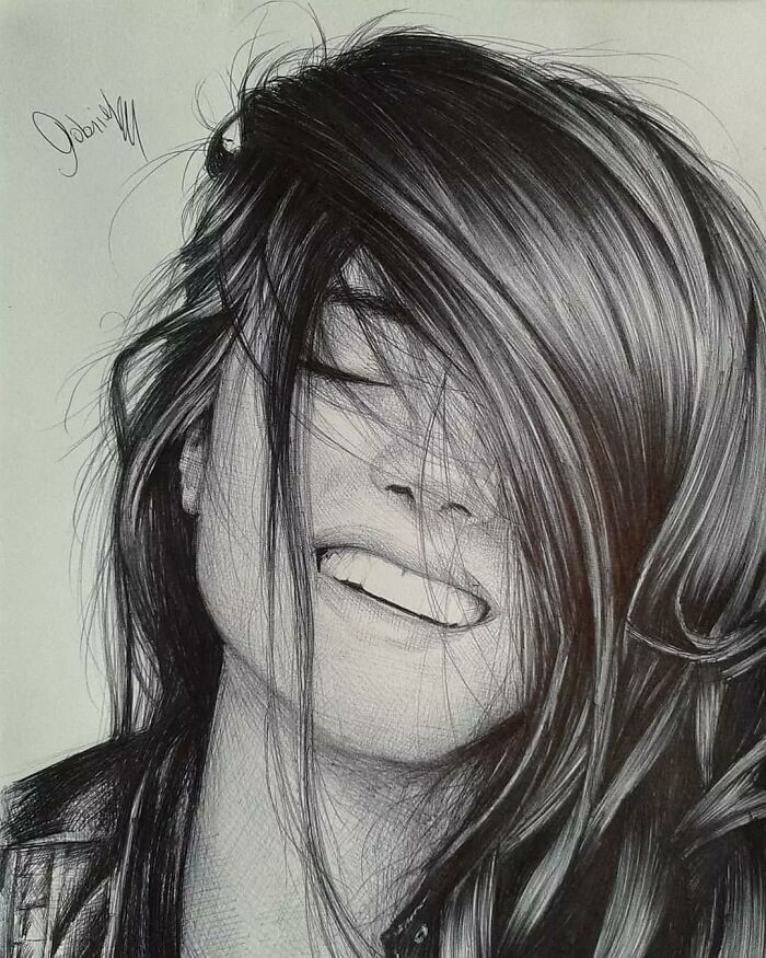 Hyperrealistic ballpoint pen portrait of a smiling woman with hair covering part of her face, showcasing detailed pen art techniques.