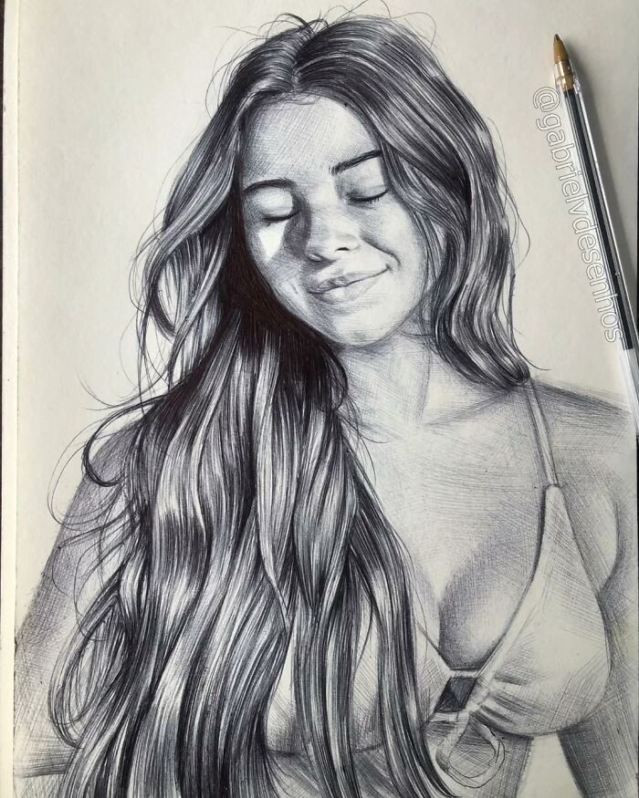 Realistic portrait drawing of a smiling woman with long hair created using only a ballpoint pen by the artist.