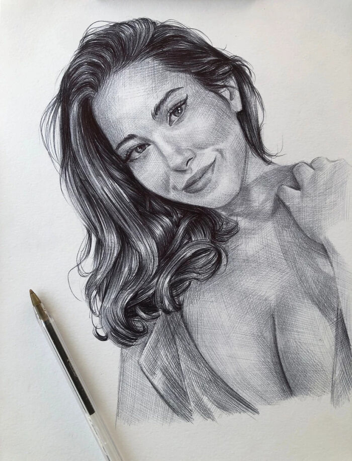 Realistic ballpoint pen portrait of a smiling woman with detailed hair and face resembling a photograph.