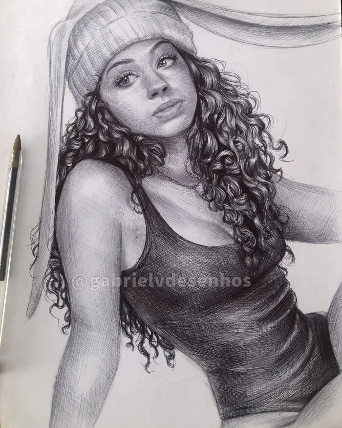 Realistic ballpoint pen portrait of a woman with curly hair wearing a beanie and tank top, showcasing detailed pen art.
