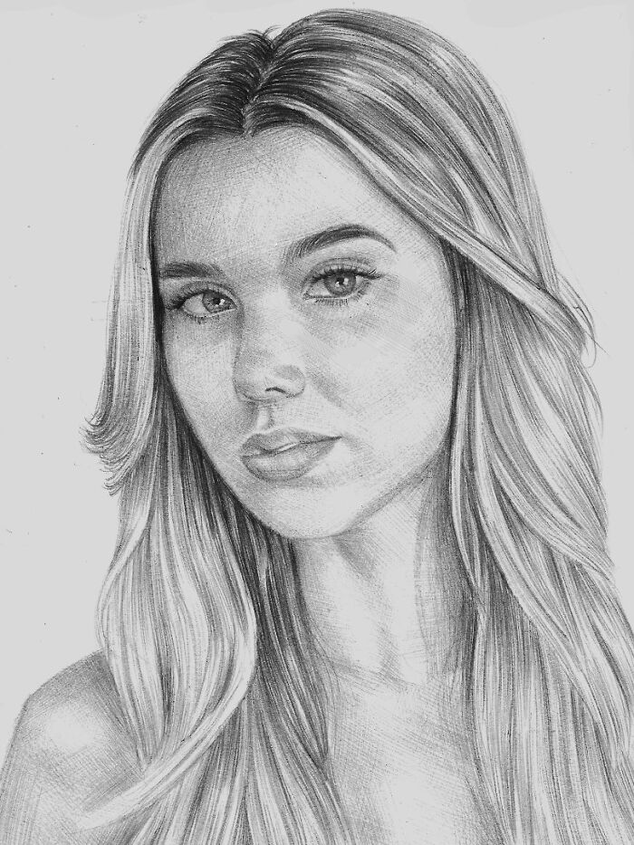 Realistic ballpoint pen portrait of a young woman with flowing hair, showcasing detailed shading and lifelike features.