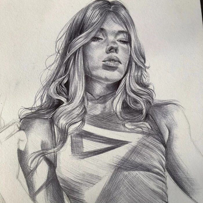 Ballpoint pen portrait of a woman with flowing hair, showcasing detailed shading that makes it look photographed.