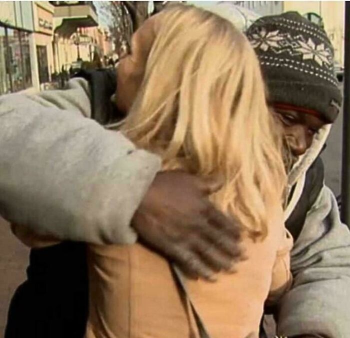 Two people sharing a warm hug outdoors, capturing a heartwarming moment of kindness and connection.