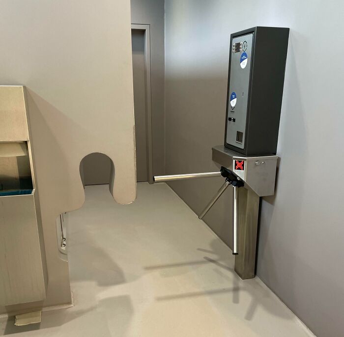 Turnstile access control system in a plain corridor, illustrating real-life dystopian scenes in the US environment.