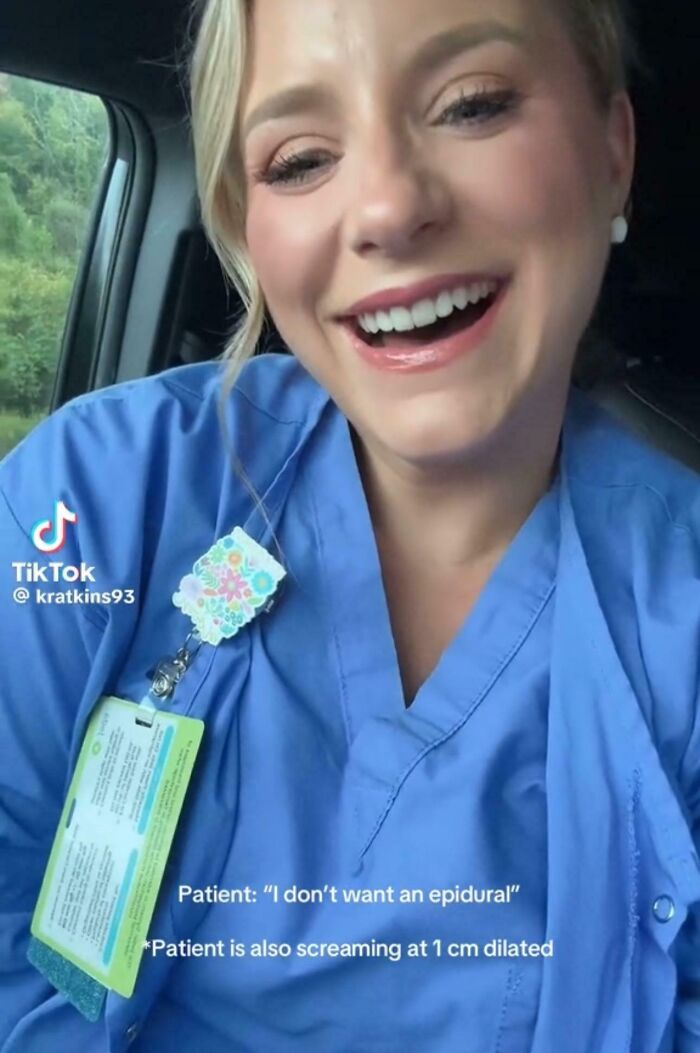 Smiling healthcare worker in blue scrubs sharing a funny TikTok screenshot about an epidural during labor.