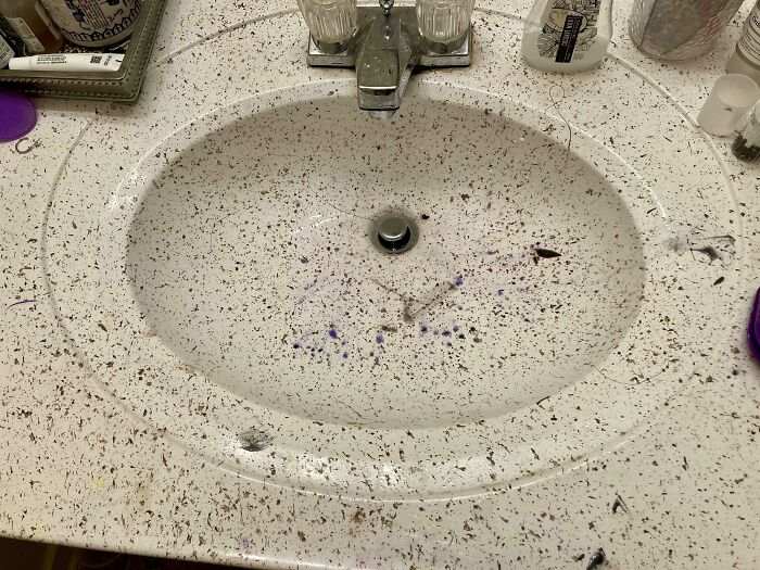 Sink and countertop covered in hair and debris, illustrating awful roommates and messy shared living spaces.