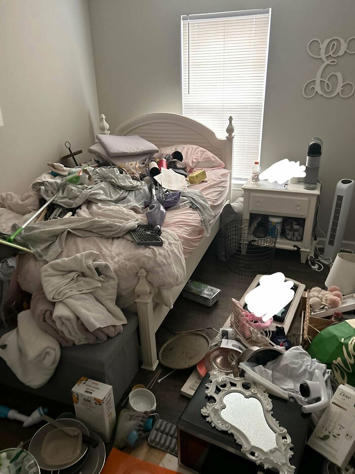 Messy bedroom showing awful roommate behavior with cluttered bed, scattered items, and unclean floor in a small living space.