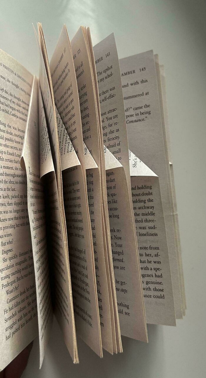 Pages of a book bent and folded in unusual ways, illustrating the concept of awful roommates and frustrating living situations.
