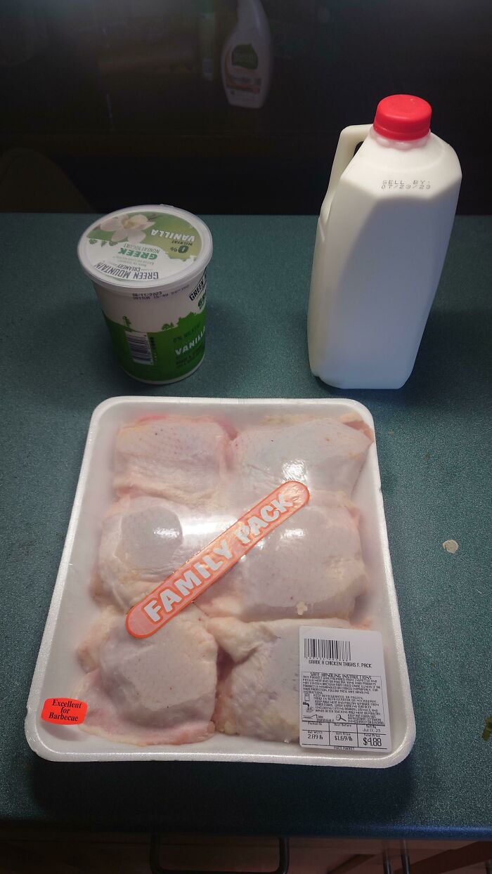 Package of raw chicken left out on kitchen counter with milk and yogurt, showing awful roommates neglecting proper food storage