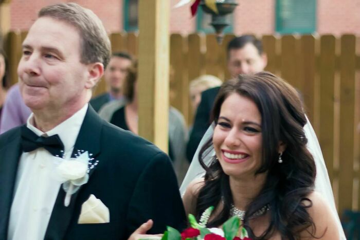 Father and daughter sharing a joyful moment at a wedding, capturing wholesome and funny family memories.