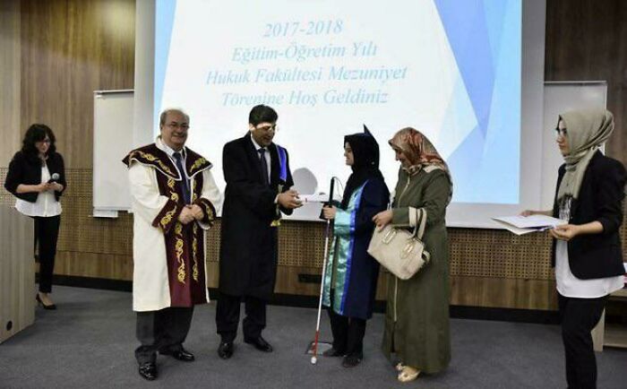 Graduation ceremony scene with a mom celebrating her achievement, showcasing happiness and wholesome moments.