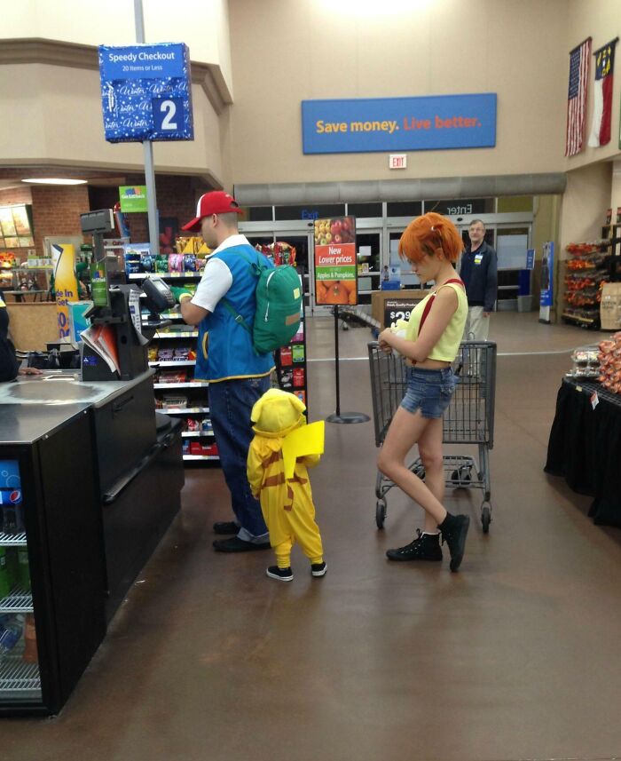 A family dressed as Pokemon characters shopping in a grocery store, showcasing funny parents in a playful setting.