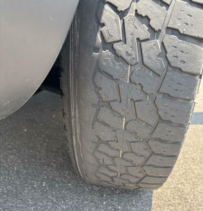 Worn-out car tire showing heavy tread damage, illustrating worst luck on vacation travel mishaps.