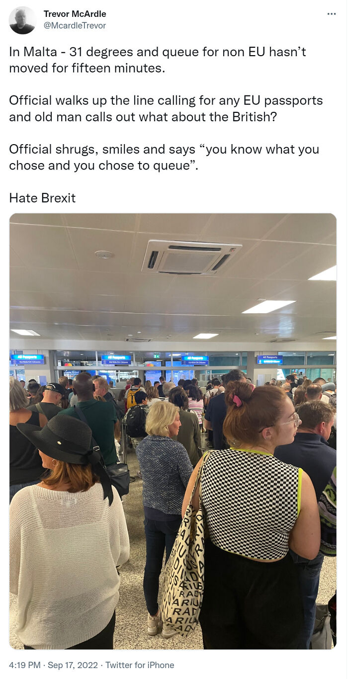 Crowded airport queue showing people facing consequences of Brexit with long wait times and passport checks.
