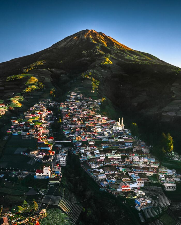 Mountain village at sunrise with terraced fields, showcasing glimpses of everyday life in Asia in a captivating landscape.
